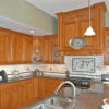 Kret's Classic Kitchen & Construction - Cherry Kitchen with Raised Panel Doors, Wood Carvings and Range Hood