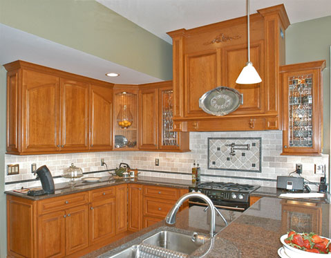 Kret's Classic Kitchen & Construction - Cherry Kitchen with Raised Panel Doors, Wood Carvings and Range Hood